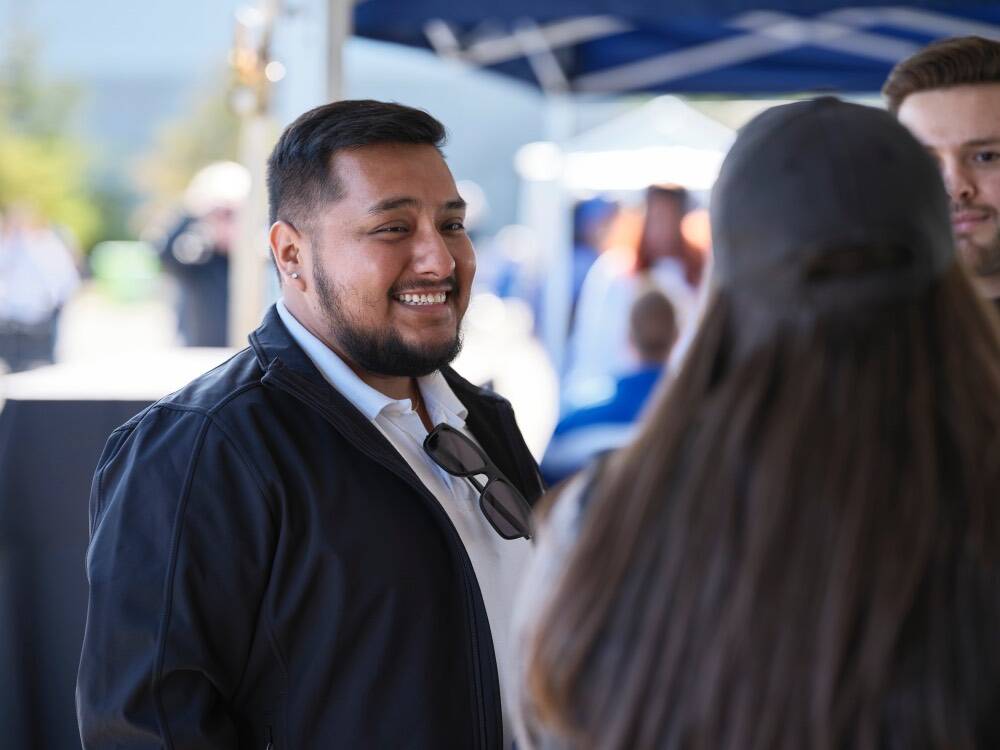 Man smiling at women